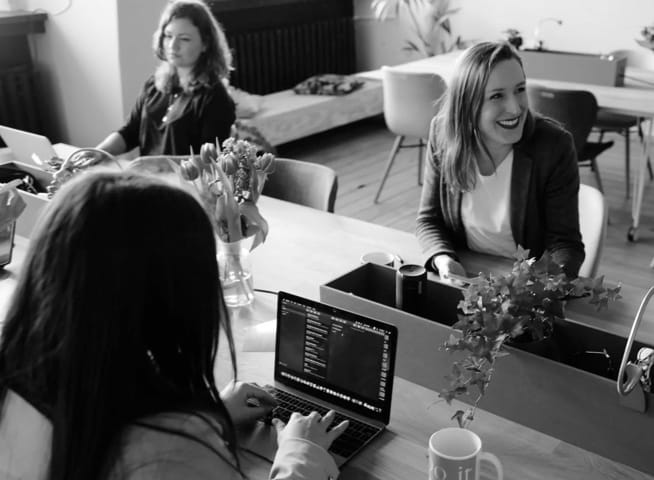 3 girls sitting at the computer in the office