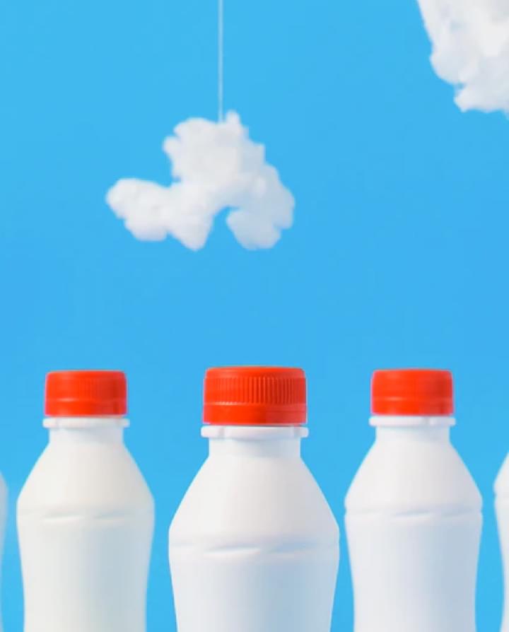 bottles with milk on the background of the sky